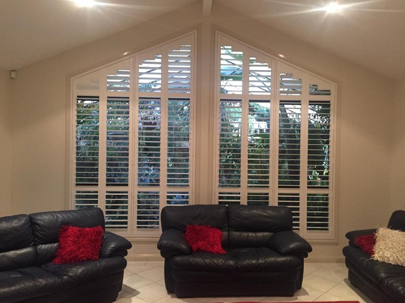 PVC Plantation Shutters on large windows with shaped upper triangle shutters