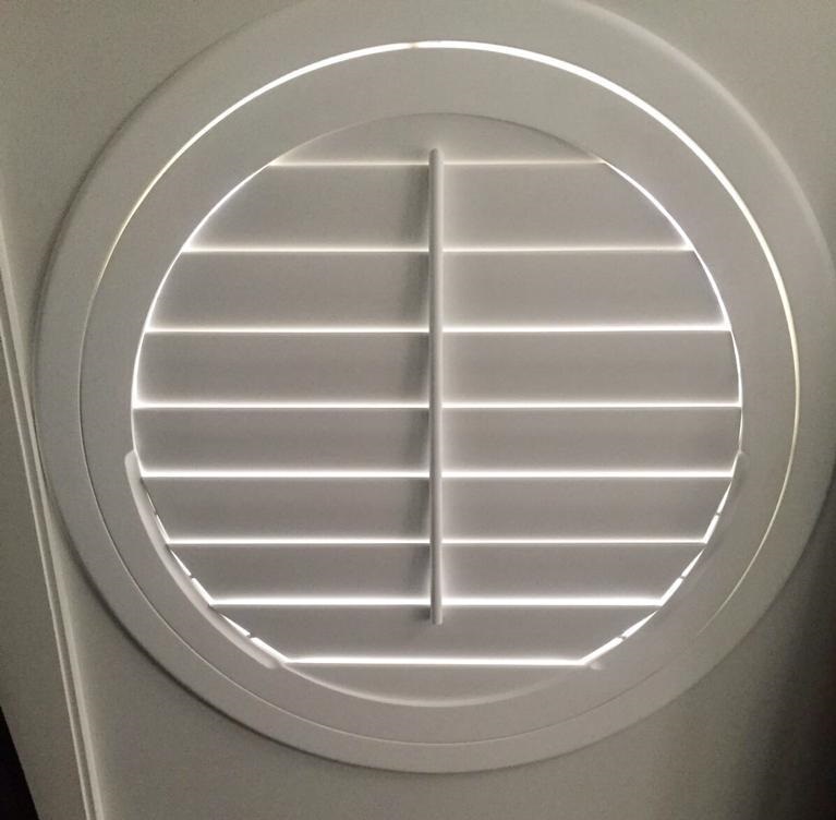 Round circle shaped plantation shutters in a white colour